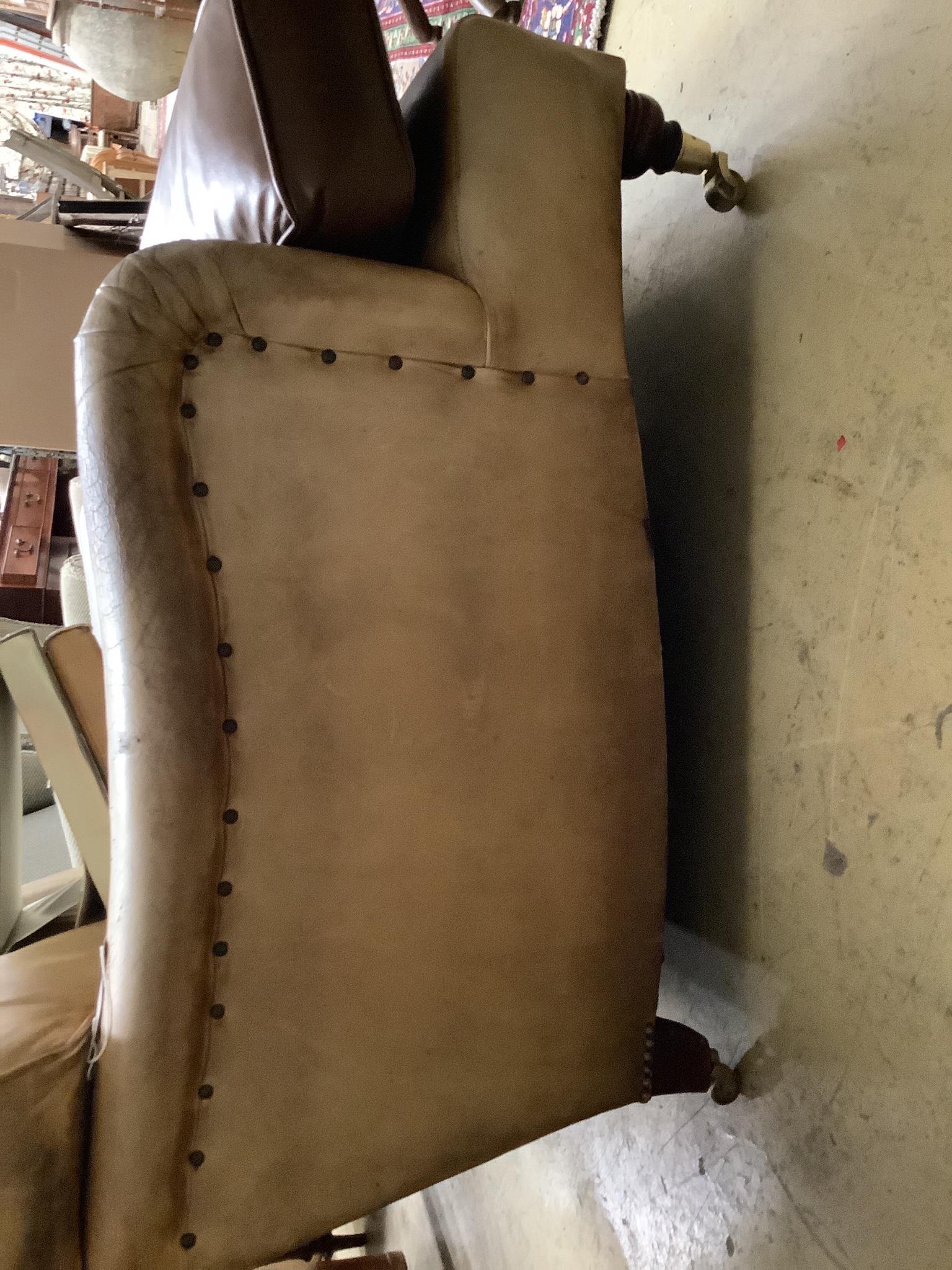 A Howard style faded brown leather club armchair, width 86cm, depth 108cm, height 74cm
